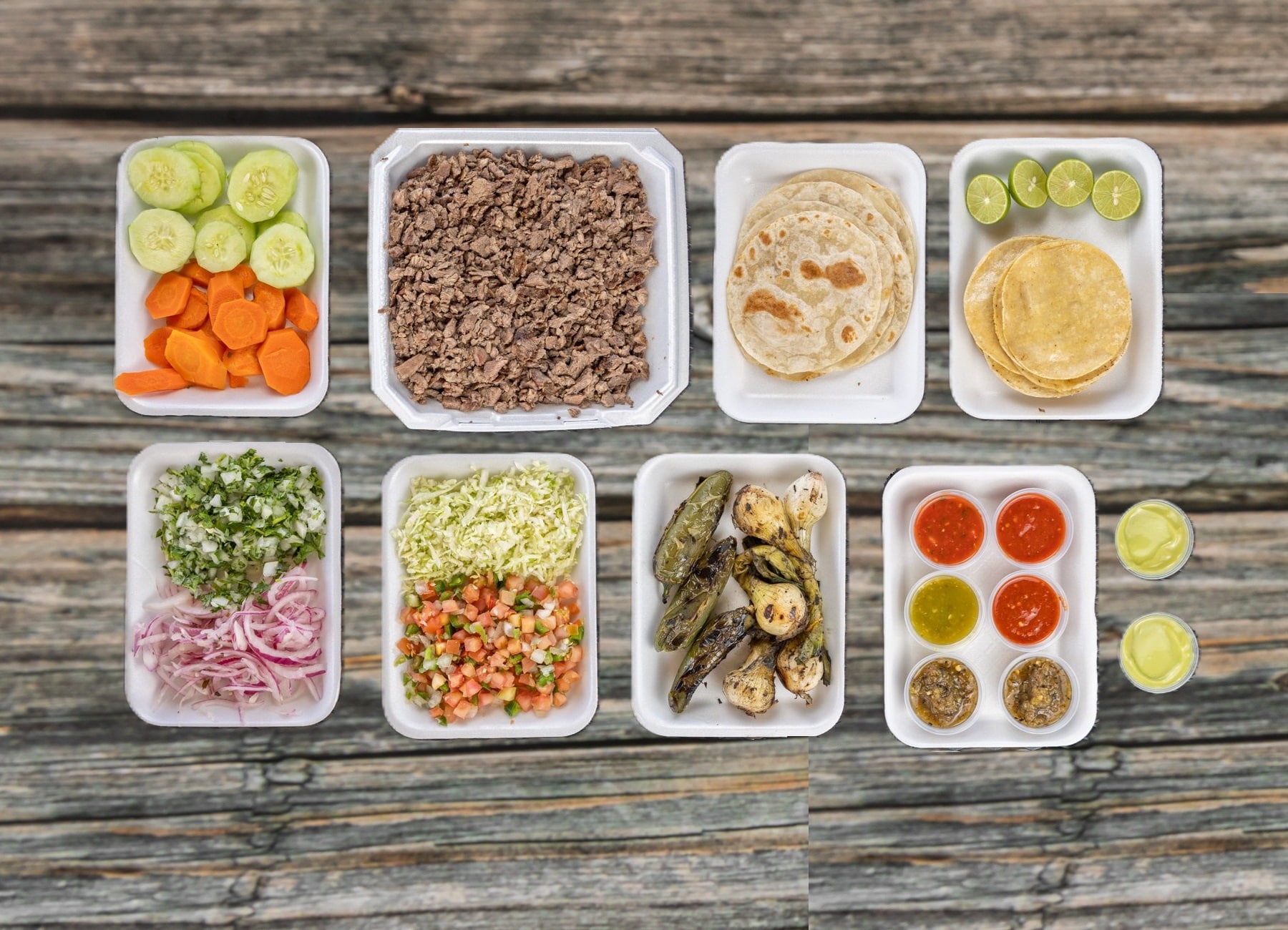 Vibrant Mexican catering event spread with fresh tacos, salsas, and sides by Ta Carbon in Phoenix, AZ